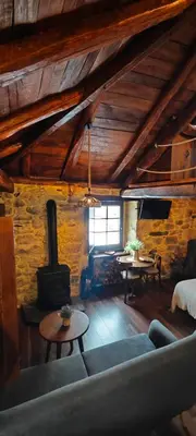 a living room with a couch and a stove at El Cuarto in Suarbol