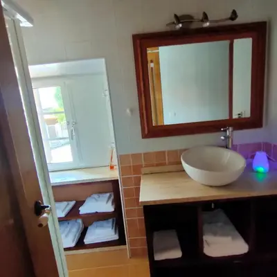 a bathroom with a sink and a mirror and towels at Eirixo in Valga