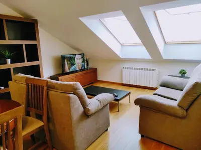 a living room with two chairs and a skylight at Figueras 5 in figueras