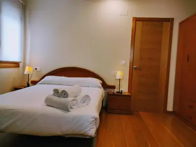 a hotel room with a bed with towels on it at Figueras 5 in figueras