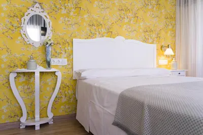 a bedroom with a white bed and a mirror at Pensión Ferradura in Melide