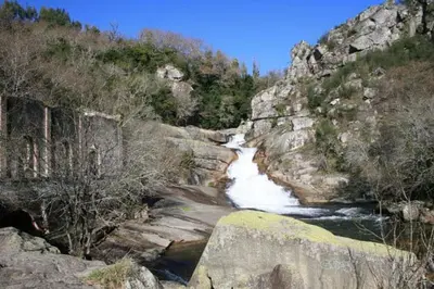 a river on a rocky hillside with aploadploadploadploadploadploadpload at Altamira in Caldas de Reis