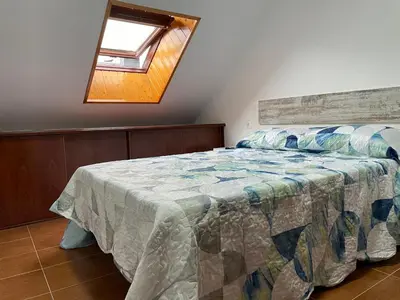 a bedroom with a bed with a quilt on it at Altamira in Caldas de Reis