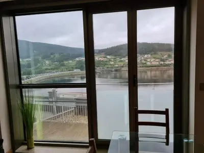 a view of a river from a room with a window at APARTAMENTOS VIVE in Viveiro