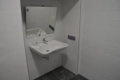 a white bathroom with a sink and a mirror at Eco dos Teixos in Casayo