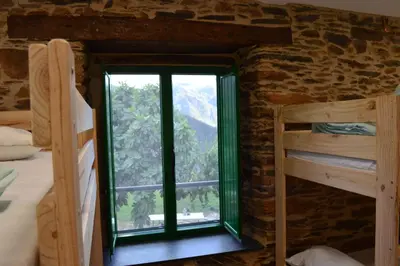 a window in a room with two bunk beds at Eco dos Teixos in Casayo