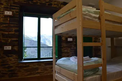 a bunk bed in a room with a window at Eco dos Teixos in Casayo