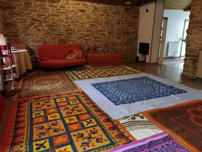 a room with lots of colorful rugs on the floor at Eco dos Teixos in Casayo