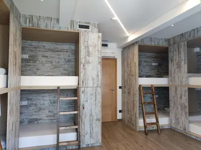 a room with four bunk beds and a ladder at THOSTEL in Santiago de Compostela