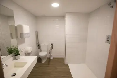 a bathroom with a toilet and a sink and a shower at THOSTEL in Santiago de Compostela
