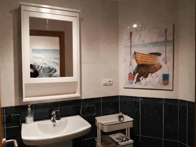 a bathroom with a sink and a mirror at San Ciprian Marinero by I Love Norte in San Ciprián
