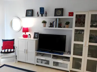 a living room with a tv on a white entertainment center at San Ciprian Marinero by I Love Norte in San Ciprián