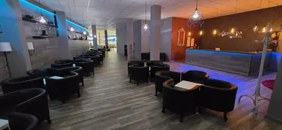 a restaurant with a row of chairs and a bar at ALBERGUE A QUEIMADA Exclusivo Peregrinos in Caldas de Reis