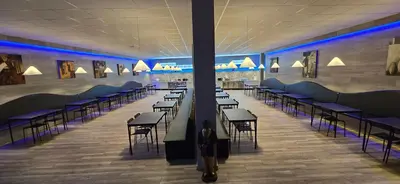 a cafeteria with rows of tables and chairs at ALBERGUE A QUEIMADA Exclusivo Peregrinos in Caldas de Reis