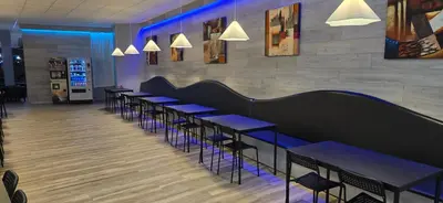 a row of tables and chairs in a restaurant at ALBERGUE A QUEIMADA Exclusivo Peregrinos in Caldas de Reis