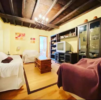 a bedroom with two beds and a television in it at Villa de Castro in Villar de los Barrios