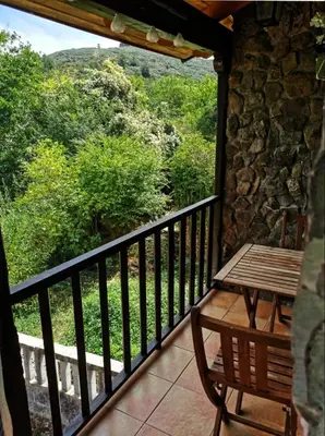 a balcony with a wooden table and a bench at Villa de Castro in Villar de los Barrios