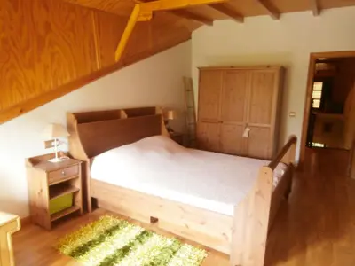 a bedroom with a wooden bed and a wooden cabinet at Villa de Castro in Villar de los Barrios