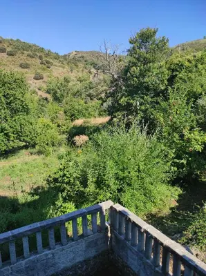 a bridge over a field with trees and bushes at Villa de Castro in Villar de los Barrios