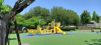 a playground with a yellow slide in a park at Apartamento Exterior Camino Inglés # a 10 min de Santiago in Sigüeiro