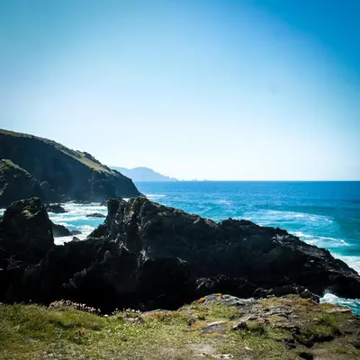 a view of the ocean from a rocky beach at Albergue Abeiro do Sor in Santa María