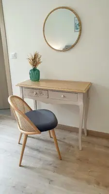 a desk with a chair and a mirror at Playa Ribeiría apartamento vacacional in Tapia de Casariego