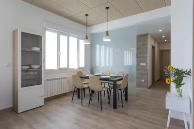a kitchen and dining room with a table and chairs at Playa Ribeiría apartamento vacacional in Tapia de Casariego