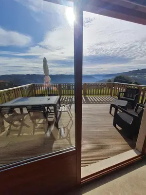 a view of a deck with a table and chairs at Casa Fondo de Vila in Chantada