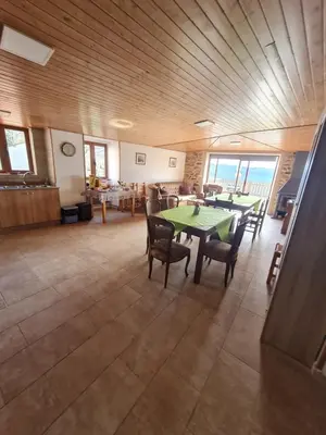 a dining room with a table and chairs in a building at Casa Fondo de Vila in Chantada