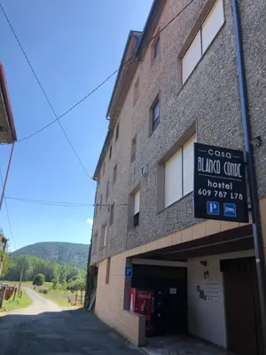 a building with a sign on the side of it at El Camino in Laza