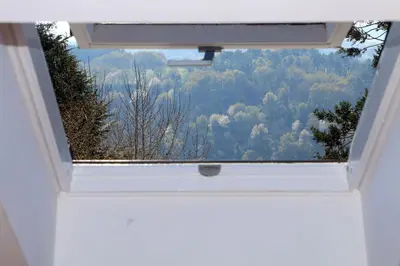 a window in a room with a view of a forest at Hotel Villa Jardín in Portomarin