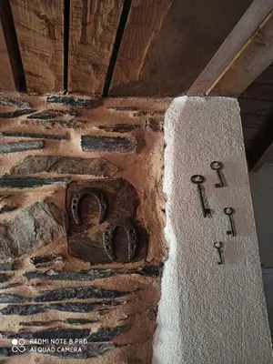 a stone wall with iron numbers on it at CASA DA LOAIRA in Quiroga