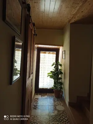 a hallway with a window and a potted plant at CASA DA LOAIRA in Quiroga