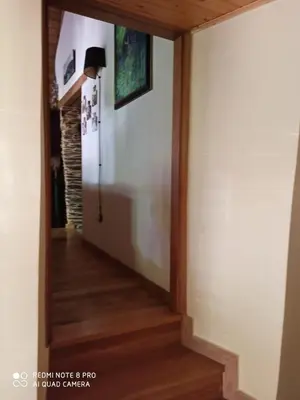 a hallway with wood floors and a white wall at CASA DA LOAIRA in Quiroga