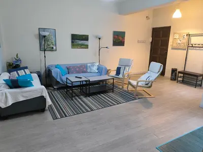 a living room with a blue couch and two chairs at Tonos de Azul in Ponferrada