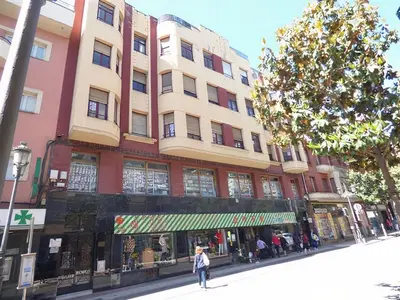 a person walking down a street in front of a building at Tonos de Azul in Ponferrada