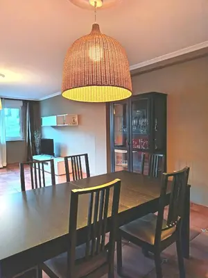 a dining room with a black table and chairs at Viveiro Histórico 2 in Viveiro