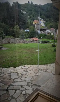 a glass window with a view of a field at Prao del Molin in Cangas del Narcea