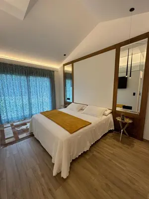 a bedroom with a large bed with a large window at Puerto Franco in Jove