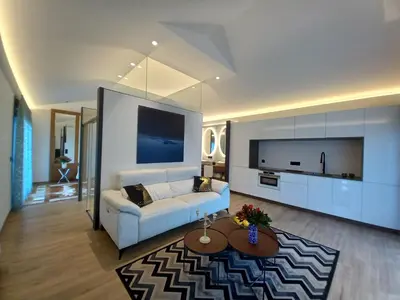 a living room with a white couch and a tv at Puerto Franco in Jove