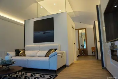 a living room with a couch and a flat screen tv at Puerto Franco in Jove