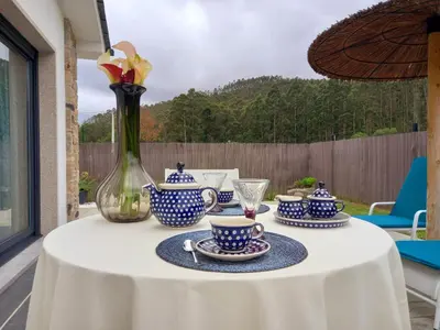 a table with blue and white cups and saucers at Puerto Franco in Jove