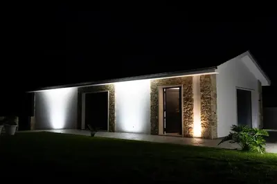 a white house lit up at night at Puerto Franco in Jove