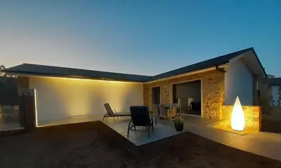 a house with a patio with a table and chairs at Aires De Míguez in Jove