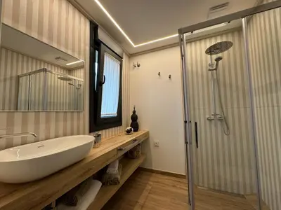 a bathroom with a white sink and a shower at Aires De Míguez in Jove
