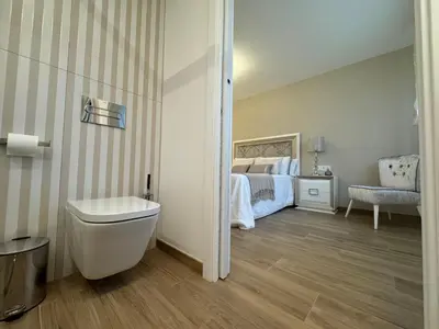 a bedroom with a bed and a toilet in it at Aires De Míguez in Jove