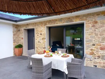 a table and chairs on a patio at Aires De Míguez in Jove