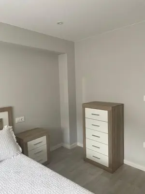a bedroom with a bed and two nightstands and a dresser at Golden Views in Viveiro