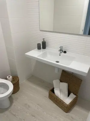 a bathroom with a sink and a toilet and a mirror at Golden Views in Viveiro