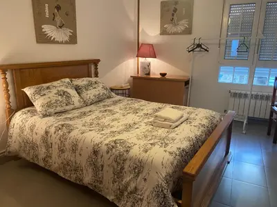 a bedroom with a bed and two windows at Minâ in Taramundi